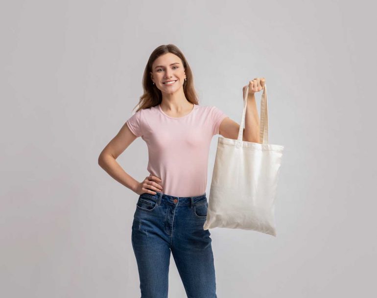 Smiling Millennial Woman Posing With Eco Tote Canvas Bag