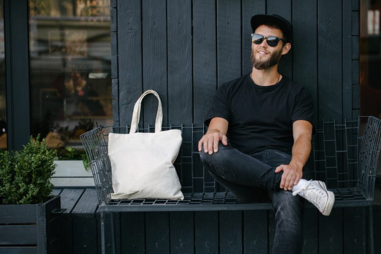 Young_Man_Next_To_White_Tote_Bag