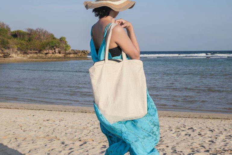 Girl_Holding_Blank_Canvas_Tote_Bag_On_Beach